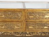 a gold chest of drawers with a mirror on top