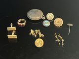 a lot of gold and silver jewelry on a black table