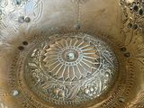 a silver bowl sitting on top of a table