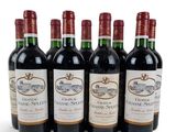 six bottles of red wine are lined up in a row