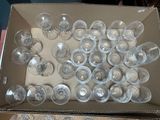 a box full of empty wine glasses sitting on a table