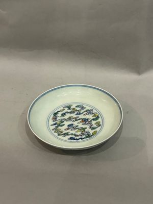 an image of a white plate with blue and green designs on it