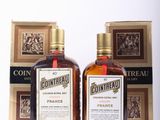 two bottles of contreau are sitting next to each other on a table