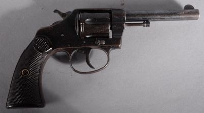 an old gun with a wooden handle on a white surface