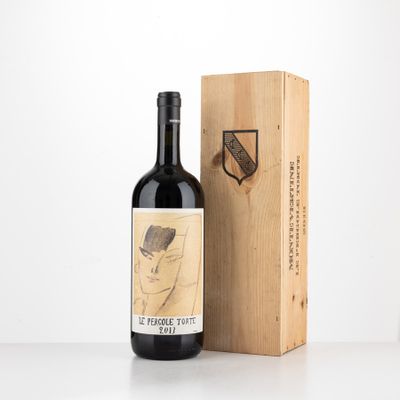 the bottle of wine is next to a wooden box with a drawing on it