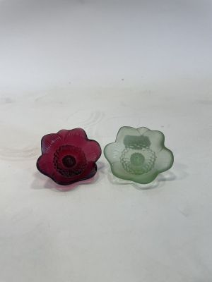 two pieces of glass sitting on a white surface