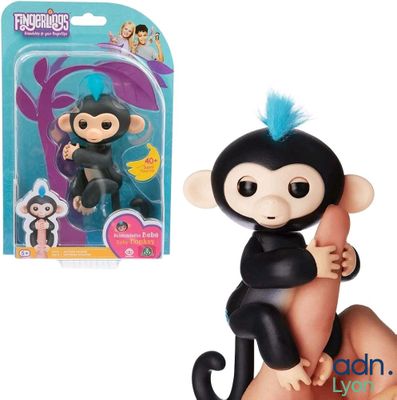 a toy monkey that is sitting on a finger