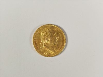a close up of a gold coin on a white surface