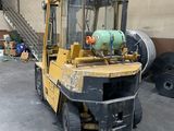 a yellow forklift truck parked in a warehouse