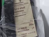 a plastic bag with a label on it that says hard shell suitcase