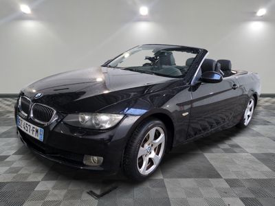 a picture of a black bmw convertible parked in a garage