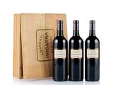 three bottles of wine in front of a wooden box