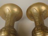 pair of antique brass vases on a white background