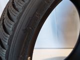 a close up of a tire on a stand with a white background