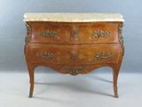a small chest of drawers with a marble top