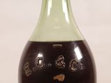 an old bottle of wine with a cork stopper on the top of it
