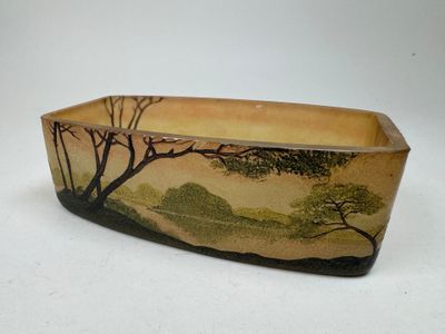 a ceramic bowl with a painting of trees on it