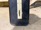 a black suitcase sitting on the ground in front of a bench