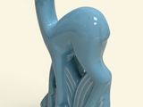 a small blue statue of a deer on a white surface