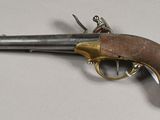 a close up of a gun on a table with a white background