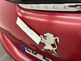 a red car with a horse emblem on it