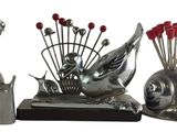 a silver sculpture of a snail and a snail with red flowers
