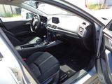 the interior of a car with the door open and the driver ' s seat down