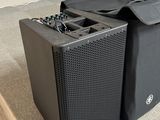two speakers sitting next to each other on the floor