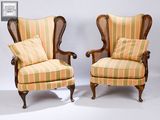 two chairs with striped upholstered upholstered cushions on them