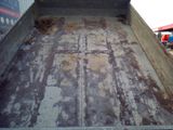 an image of a dirty truck bed in the back of a truck