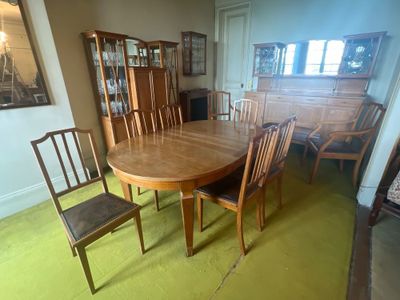 a dining room table with chairs and a china cabinet