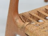 an image of a close up of a wooden chair with a woven seat