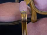 a pink chair with a gold frame and a pink chair with a gold frame