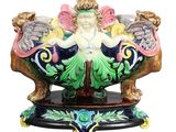 une figurine représentant une femme assise dans un bol posé sur un socle