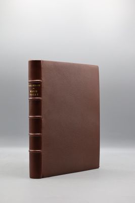un livre brun posé sur une surface blanche