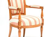 striped upholstered arm chair with wooden frame and wood legs