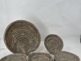 six plates and a bowl sitting on a table with a vase in the background