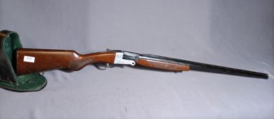 the rifle is laying on the table with a hat on it
