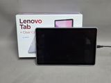 a tablet computer sitting on a table next to a box of lenovo tabs