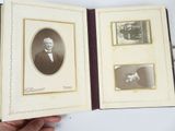 someone is holding a book with a picture of a man and a dog