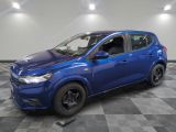 a blue car is parked on a checkered floor in a garage
