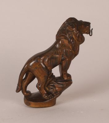 an image of a bronze statue of a lion on a rock