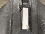 a close up of a black and white instrument in a case