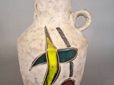 a white vase with a colorful design on it