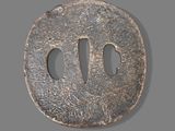 an image of a round iron tsuba with two holes