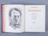 an open book with a drawing of a man ' s face on it