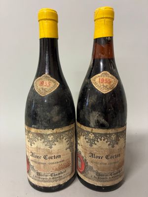 two bottles of wine sitting next to each other on a table