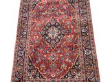 an antique persian rug with a medallion design on a red ground