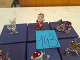 six small christmas ornaments on a table with a blue sign