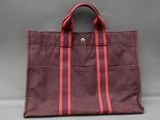 a brown and red tote bag sitting on top of a table